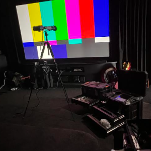 Real home theatre calibration setup with test pattern and measurement microphone